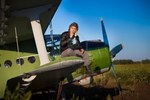 10327905-smoking-pilot-in-the-helmet-is-sitting-on-the-wing-of-a-vintage-plane.jpg